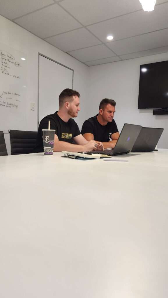 Jakob, owner of Unreal Media sitting with his client Nathan James, Owner of Fitness Cartel Australia planning out content and putting together a strategy for Fitness Cartel marketing.