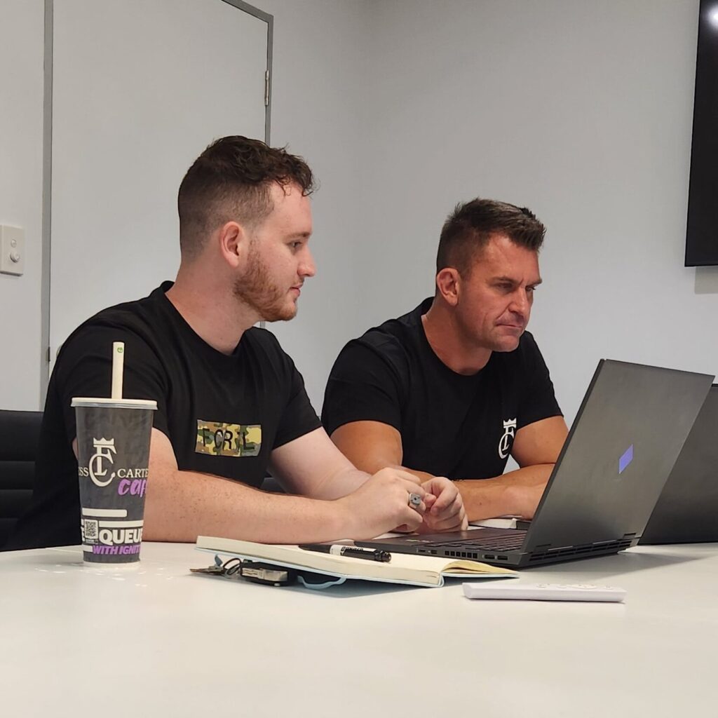 Jakob, owner of Unreal Media sitting with his client Nathan James, Owner of Fitness Cartel Australia planning out content and putting together a strategy for Fitness Cartel marketing.