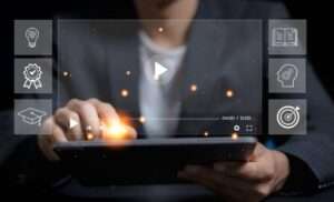A guy in front of a computer showing the benefits of video marketing.