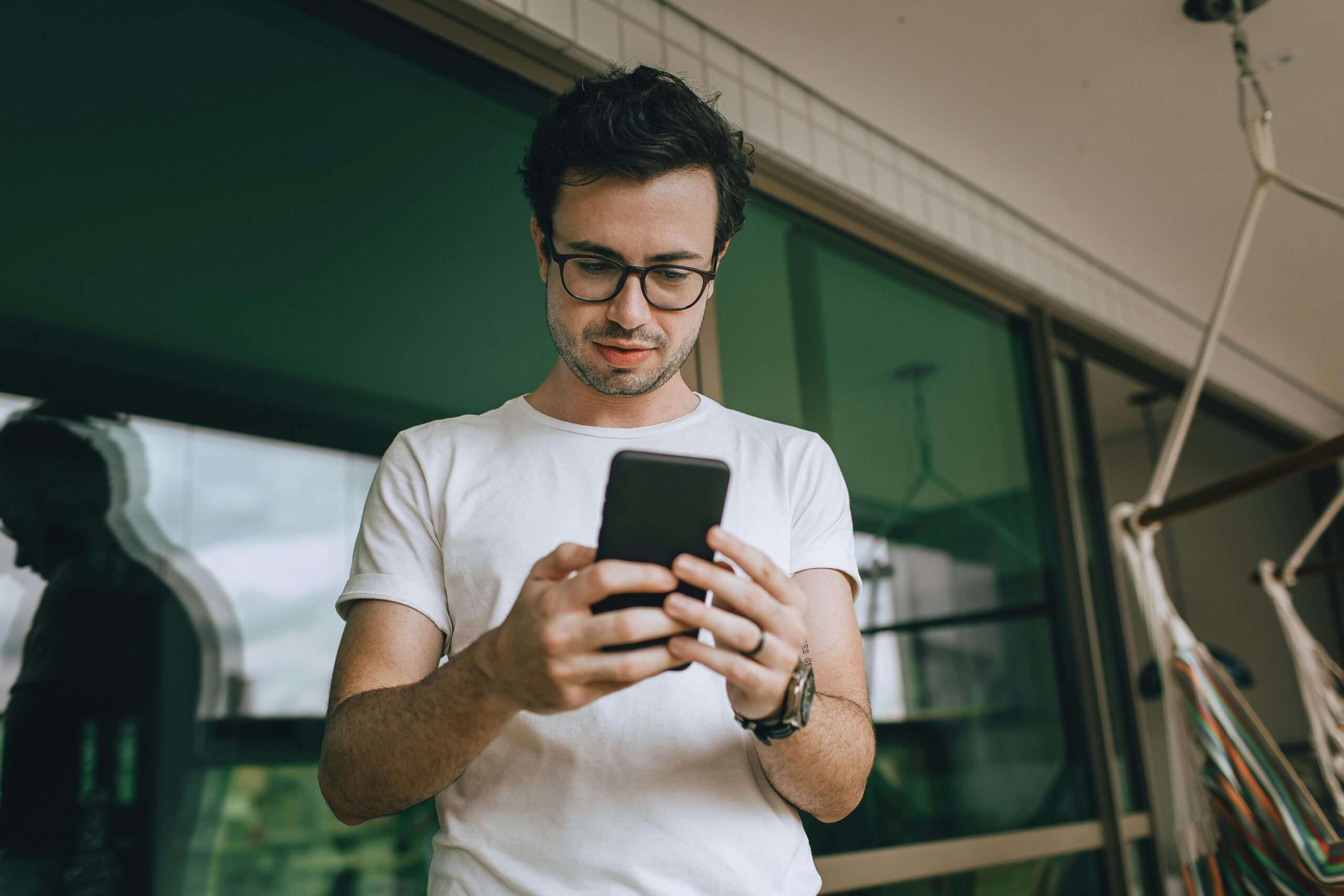 Man engaging with social media on his smartphone, illustrating how to turn social media engagement into real business growth through digital marketing strategies.