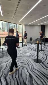 A behind-the-scenes look at a professional video shoot for a business in a modern office setting, showcasing the team at work for a Video Marketing Gold Coast project.