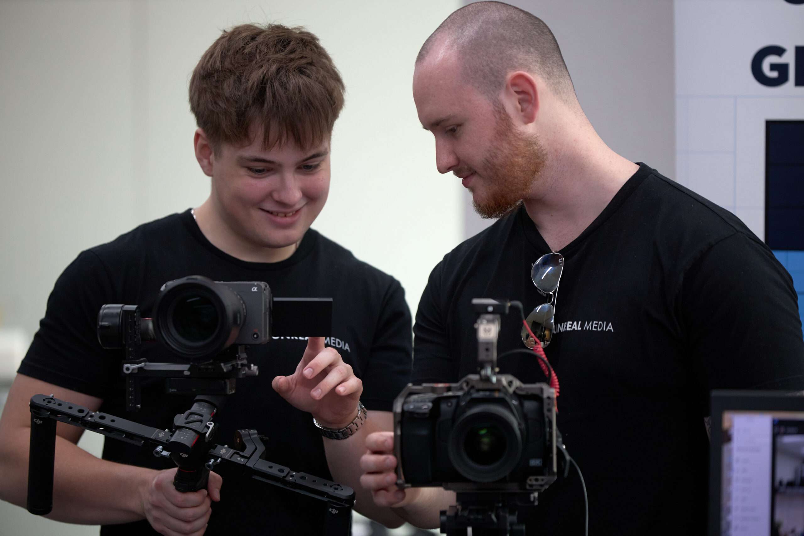 Two team members from Unreal Media working on video equipment during a video marketing Perth project.