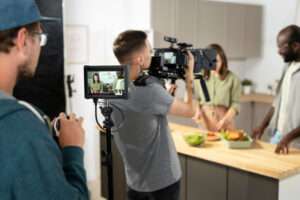 Filming an explainer video titles "What is Video Production?" in modern kitchen