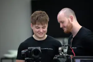 Brisbane video team from Unreal Media reviewing footage on professional camera gear during a client shoot