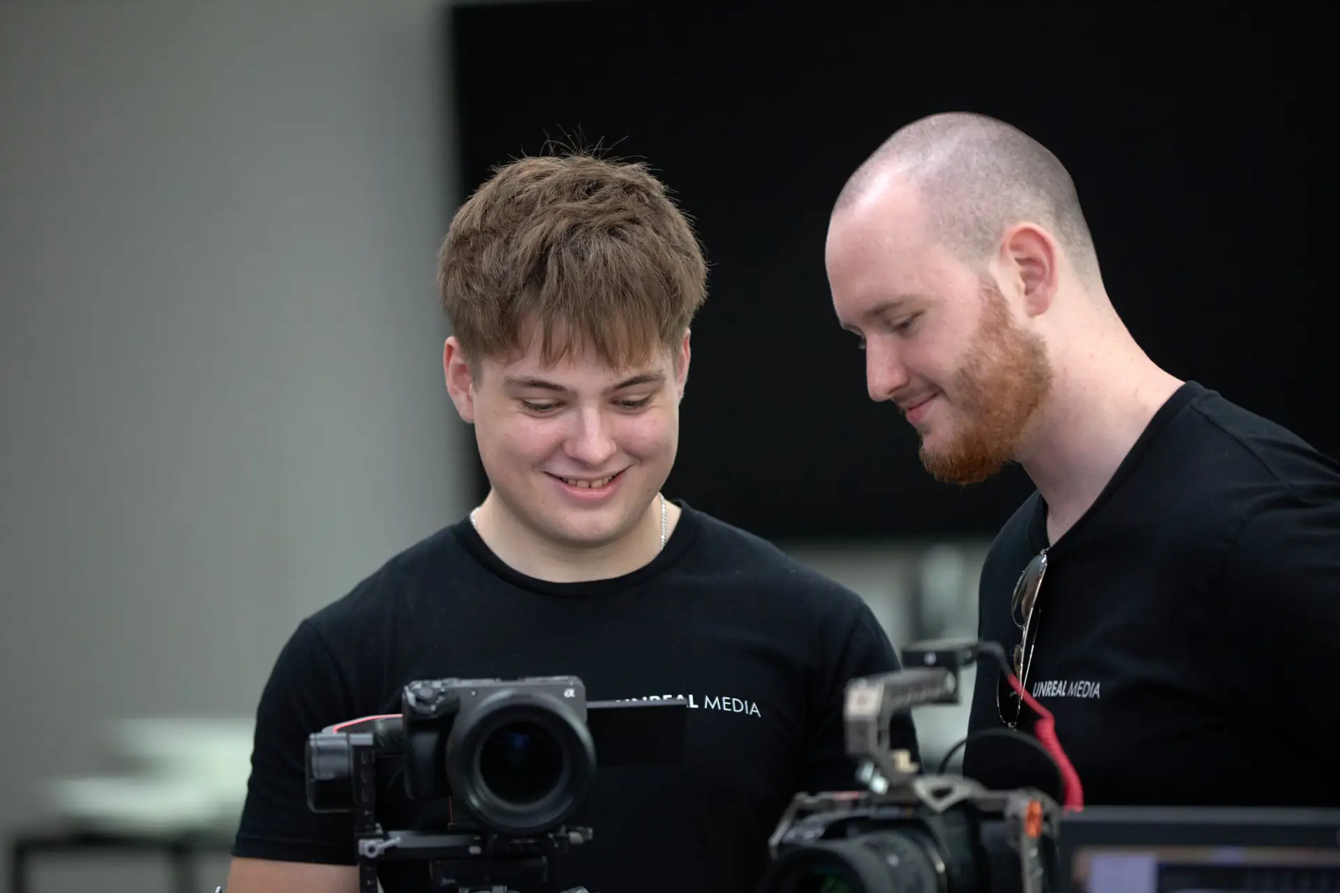 Brisbane video team from Unreal Media reviewing footage on professional camera gear during a client shoot